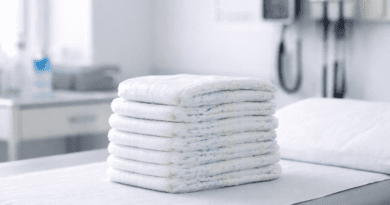 Stack of diapers on a doctor's table.