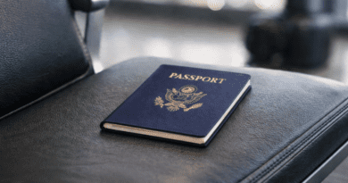 Passport resting on airport seat.