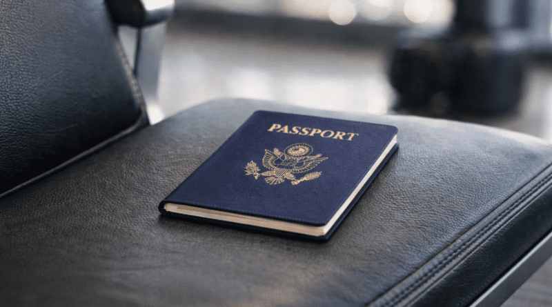 Passport resting on airport seat.