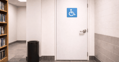 Accessible restroom door in hallway.