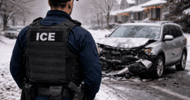 Ice agent standing in front of a totaled car.